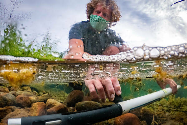 Brett Peters of the Notre Dame Environmental Change Initiative checks instruments at the Linked Experimental Ecosystem Facility (ND LEEF) in St. Patrick's County Park.