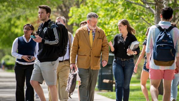 Professor Mike Desch (center) walks and talks with undergraduate research assistant Sienna Wdowik