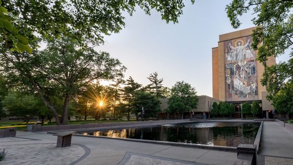 reflecting pool in front of the Hesburgh Library at sunset