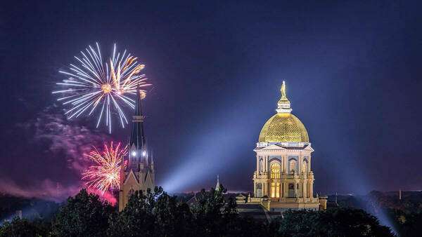Golden dome and Basilica with fireworks in the sky