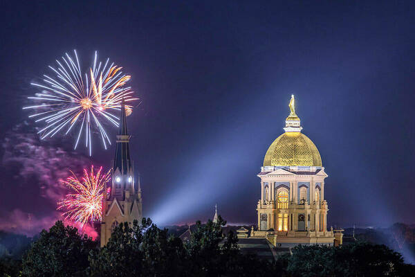 Golden dome and Basilica with fireworks in the sky